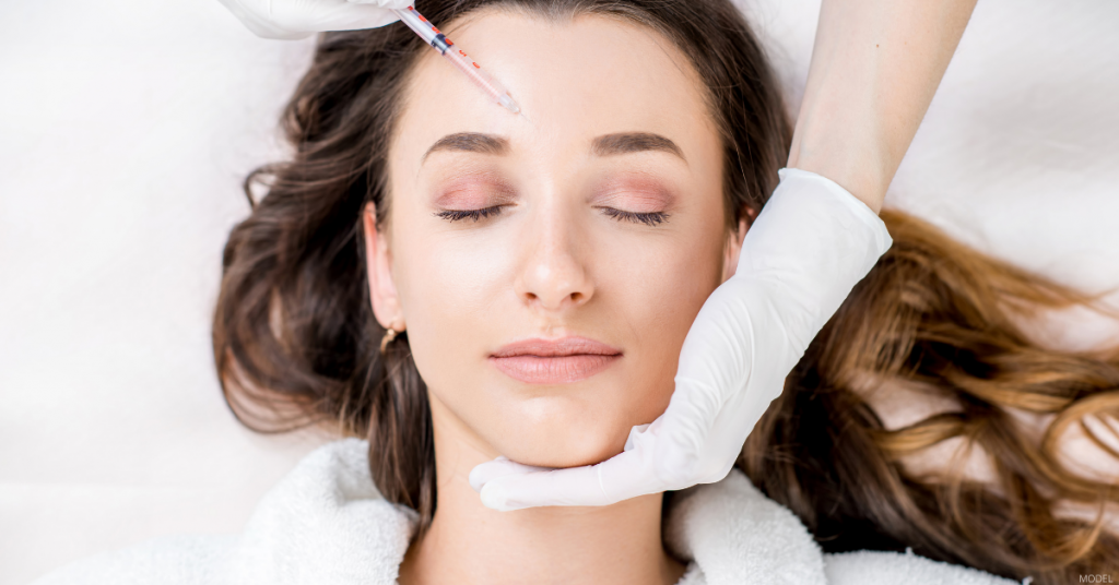 A woman receives dermal filler injections.