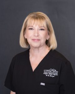 Kathleen Kyllonen in black scrubs at McNemar Cosmetic Surgery